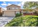 Attractive home with a two-car garage, a front porch, and a lush green lawn at 6132 W 113Th Ave, Westminster, CO 80020