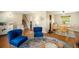 Inviting living room with blue chairs, modern decor, and staircase access at 6132 W 113Th Ave, Westminster, CO 80020