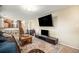 Spacious living area with a large wall-mounted TV, comfortable seating, and staircase view at 6132 W 113Th Ave, Westminster, CO 80020