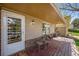Inviting front porch with a chair set on a wood deck, offering a welcoming entrance at 6132 W 113Th Ave, Westminster, CO 80020