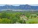 Scenic aerial view of property showcasing mountain views, mature trees and open space at 4682 Chatham St, Boulder, CO 80301