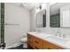 Well-lit bathroom with double sinks, wood vanity, and stylish mirrors at 4682 Chatham St, Boulder, CO 80301