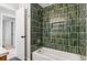 Beautiful bathroom showcasing stylish green tile in shower and tub area with storage niche at 4682 Chatham St, Boulder, CO 80301