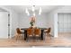 Dining room featuring modern light fixture, hardwood floors, and comfortable seating around a stylish table at 4682 Chatham St, Boulder, CO 80301
