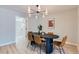 Dining room with an oval table, six chairs, a modern lighting fixture, and hardwood flooring at 4682 Chatham St, Boulder, CO 80301