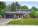 Two-story home featuring a two-car garage, brick accents, a front lawn with landscaping and curb appeal at 4682 Chatham St, Boulder, CO 80301