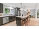 Modern kitchen with stainless steel appliances, a large center island with seating, and stylish light fixtures at 4682 Chatham St, Boulder, CO 80301