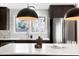 Bright kitchen with a window above the sink, white quartz countertops, stainless appliances, and modern pendant lighting at 4682 Chatham St, Boulder, CO 80301