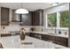 Modern kitchen features stainless steel appliances, a white quartz countertop, and sleek, dark cabinets at 4682 Chatham St, Boulder, CO 80301
