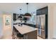Modern kitchen features stainless steel appliances, black cabinets, and a marble island with bar stool seating at 4682 Chatham St, Boulder, CO 80301