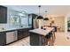 Kitchen area with a white marble island with seating, black cabinets, modern lighting, and stainless steel appliances at 4682 Chatham St, Boulder, CO 80301