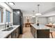 Open-concept kitchen with stainless steel appliances, a center island, and seamless flow into the dining area at 4682 Chatham St, Boulder, CO 80301