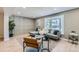 Living room area has hardwood floors, natural lighting, a neutral color palette, and stylish accent furniture at 4682 Chatham St, Boulder, CO 80301