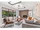 Open living room featuring a brick fireplace, skylights, and sliding glass doors to backyard at 4682 Chatham St, Boulder, CO 80301
