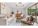 Bright living room with hardwood floors, stylish rug, and modern furniture near sliding glass doors at 4682 Chatham St, Boulder, CO 80301