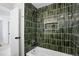 Shower with unique tiling, new shower head, and convenient built in shelf at 4682 Chatham St, Boulder, CO 80301