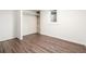 Basement room with a window and closet, showcasing wood-look floors and modern accents at 3306 N Gilpin St, Denver, CO 80205