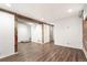 Finished basement showcasing wood-look floors, exposed brick, and modern accents at 3306 N Gilpin St, Denver, CO 80205