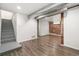 Finished basement showcasing wood-look floors, exposed brick, and modern accents at 3306 N Gilpin St, Denver, CO 80205