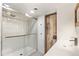 Modern bathroom featuring subway tiles, glass shower and a sliding barn door accent at 3306 N Gilpin St, Denver, CO 80205