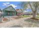 Street view of a quaint green home with rock and mulch landscaping at 3306 N Gilpin St, Denver, CO 80205