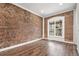 Spacious living room featuring hardwood floors and exposed brick accent wall at 3306 N Gilpin St, Denver, CO 80205