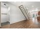 Open living area with hardwood floors and modern staircase, filled with natural light at 3306 N Gilpin St, Denver, CO 80205