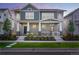 Two-story townhome with gray siding, front porch, and landscaping at 6347 N Emporia St, Denver, CO 80238