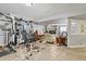 Basement featuring exercise equipment and sitting area with built-in shelving and a window at 10153 Pagosa St, Commerce City, CO 80022