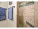 Bathroom featuring a tiled shower with stone floor and decorative accent tiles at 10153 Pagosa St, Commerce City, CO 80022