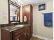 Bathroom featuring single sink vanity with granite countertop and built-in storage cabinet at 10153 Pagosa St, Commerce City, CO 80022