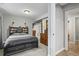 Bedroom featuring neutral paint, carpet, and a doorway leading to the bathroom at 10153 Pagosa St, Commerce City, CO 80022