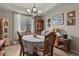 Bright dining room with a chandelier, a round table with a lace tablecloth, and large window with natural light at 10153 Pagosa St, Commerce City, CO 80022