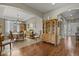 An open concept dining room with tile floors that flow into hardwood floors and an open archway with a hutch at 10153 Pagosa St, Commerce City, CO 80022