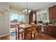 Cozy dining area adjacent to kitchen with a sliding glass door and built in desk at 10153 Pagosa St, Commerce City, CO 80022