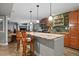 Kitchen featuring breakfast bar with seating, granite countertops, and stainless appliances at 10153 Pagosa St, Commerce City, CO 80022