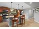 Kitchen featuring breakfast bar with seating, granite countertops, stainless appliances and stone backsplash at 10153 Pagosa St, Commerce City, CO 80022