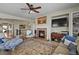 Cozy living room featuring a brick fireplace, modern decor, and a built-in entertainment center at 10153 Pagosa St, Commerce City, CO 80022