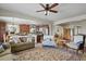 Open-concept living room that flows into the kitchen with hardwood flooring and neutral tones at 10153 Pagosa St, Commerce City, CO 80022