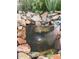 Close-up of a rock-lined pond with a small fountain feature, creating a peaceful and serene ambiance at 10153 Pagosa St, Commerce City, CO 80022