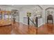 Upstairs hallway featuring hardwood floors, a wooden banister and classic home decor at 10153 Pagosa St, Commerce City, CO 80022