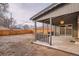 A covered porch overlooks the backyard and features tiled flooring and wood supports at 3045 Kearny Street, Denver, CO 80207