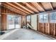 Unfinished basement with exposed wood framing ready for customization with sliding door access at 3045 Kearny Street, Denver, CO 80207