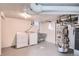 Basement laundry area featuring washer, dryer, utility sink and water heater at 3045 Kearny Street, Denver, CO 80207