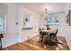 Bright dining room featuring modern light fixture, hardwood floors, and decorative animal hide rug at 3045 Kearny Street, Denver, CO 80207