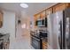 Modern kitchen featuring stainless steel appliances, tile floors, and ample counter space at 3045 Kearny Street, Denver, CO 80207