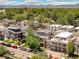 Overhead aerial view of a neighborhood with modern homes and lush green trees with mountain view at 3957 Utica St, Denver, CO 80212