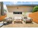 Backyard patio with comfortable outdoor seating, fire pit, and manicured landscaping at 3957 Utica St, Denver, CO 80212