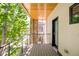 Private balcony with wood flooring, stone pillar and views of green trees and neighborhood at 3957 Utica St, Denver, CO 80212