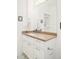 Bathroom featuring a white sink with a large mirror, light fixtures, and decorative towels at 3957 Utica St, Denver, CO 80212